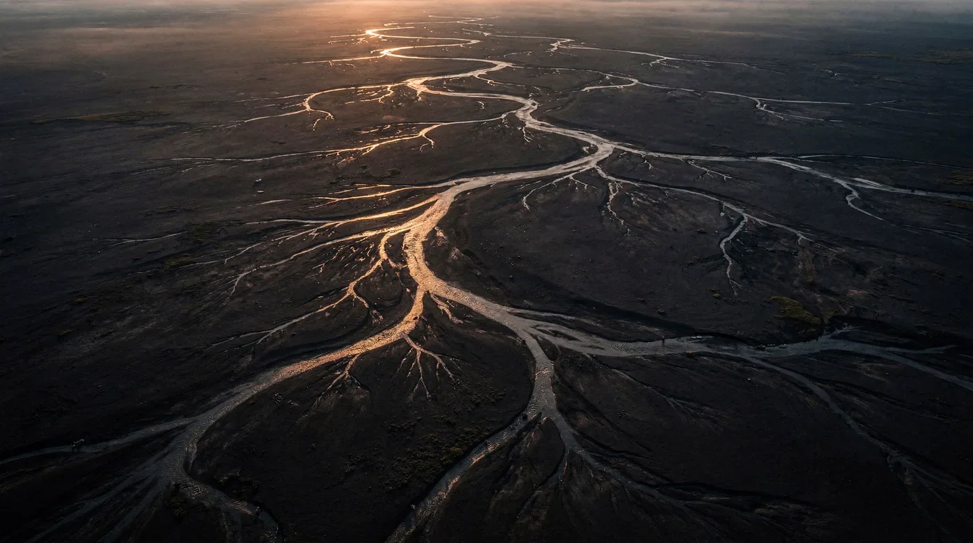 Aerial view of a braided river delta at dawn